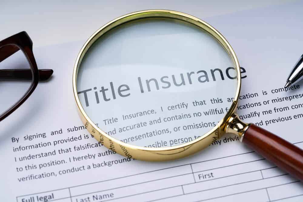 a magnifying class sitting on top of a title insurance form
