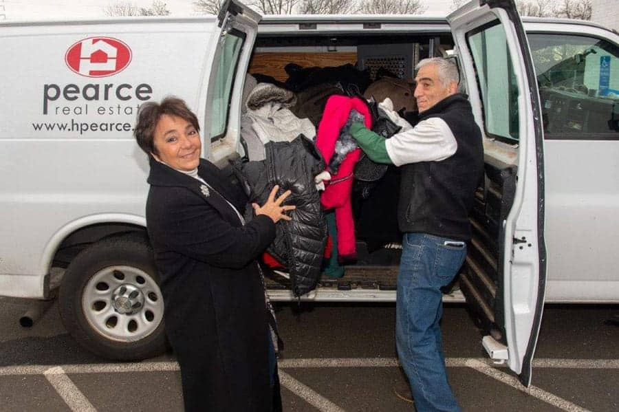 Pearce Real Estate President helping to load the van for Pearce Real Estate's Coat Drive