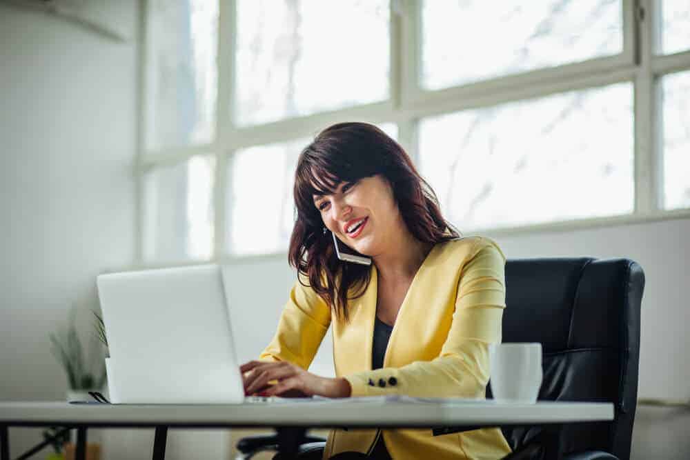 A female Relocation Coordinator speaking to a client on the phone