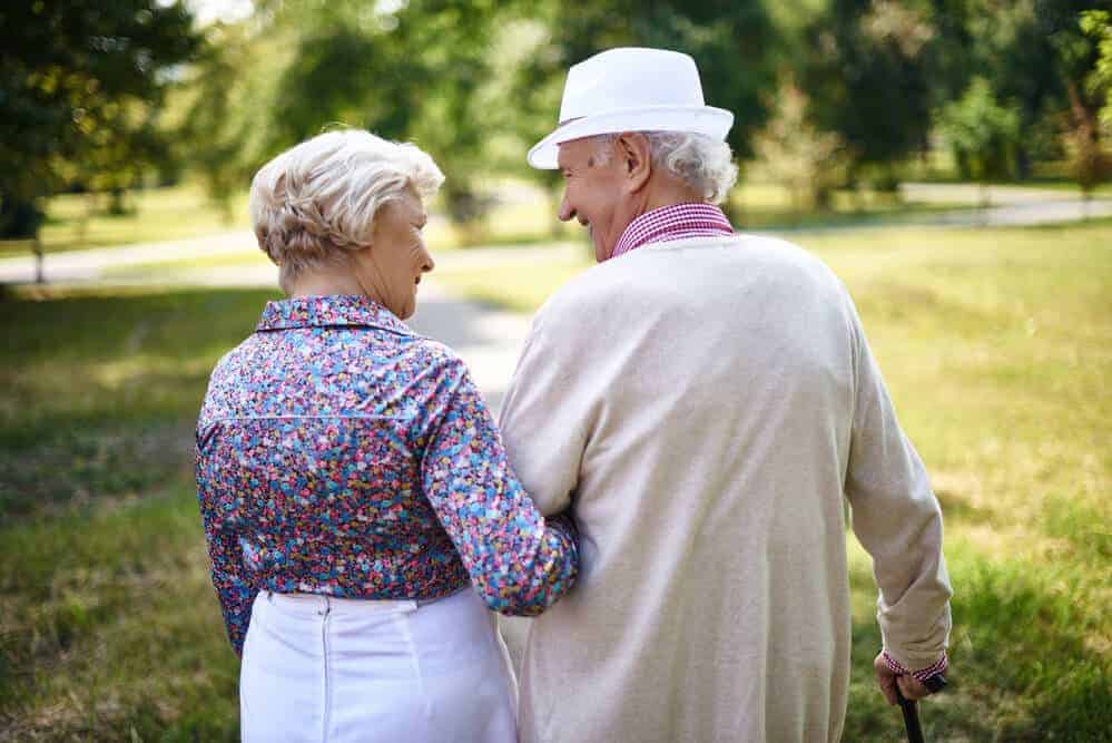 Senior couple walking in park