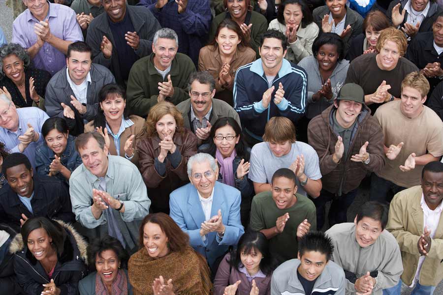 A group of people cheering and clapping