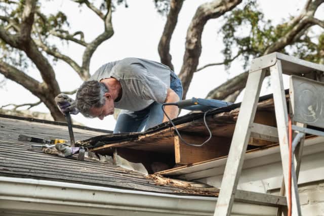 A contractor repairing a leaky roof