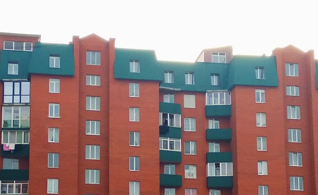 Brick Apartment Building with metal green roofing