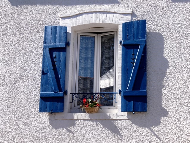 Widow with white trim and blue shutters